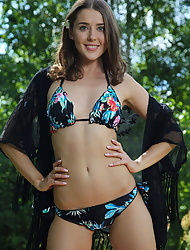 Brunette Davina E shows off her incredible body in a bikini outside